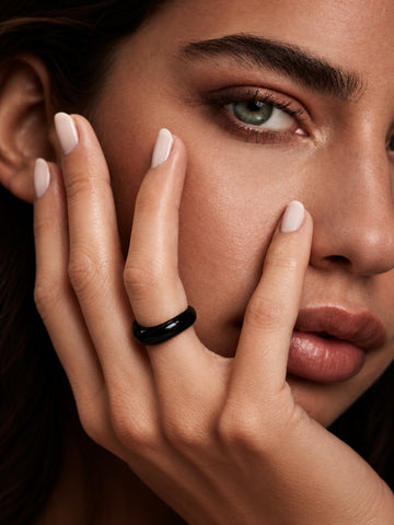 Niska glossy black statement replica ring worn on model hand