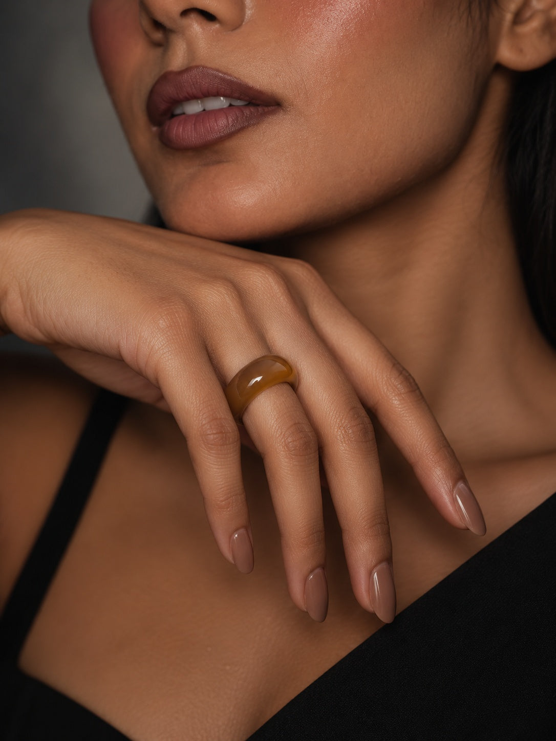 Niska amber brown dome replica ring worn on model's hand