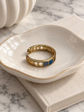 Niska blue and grey mosaic adjustable gold-tone ring in ivory ceramic dish