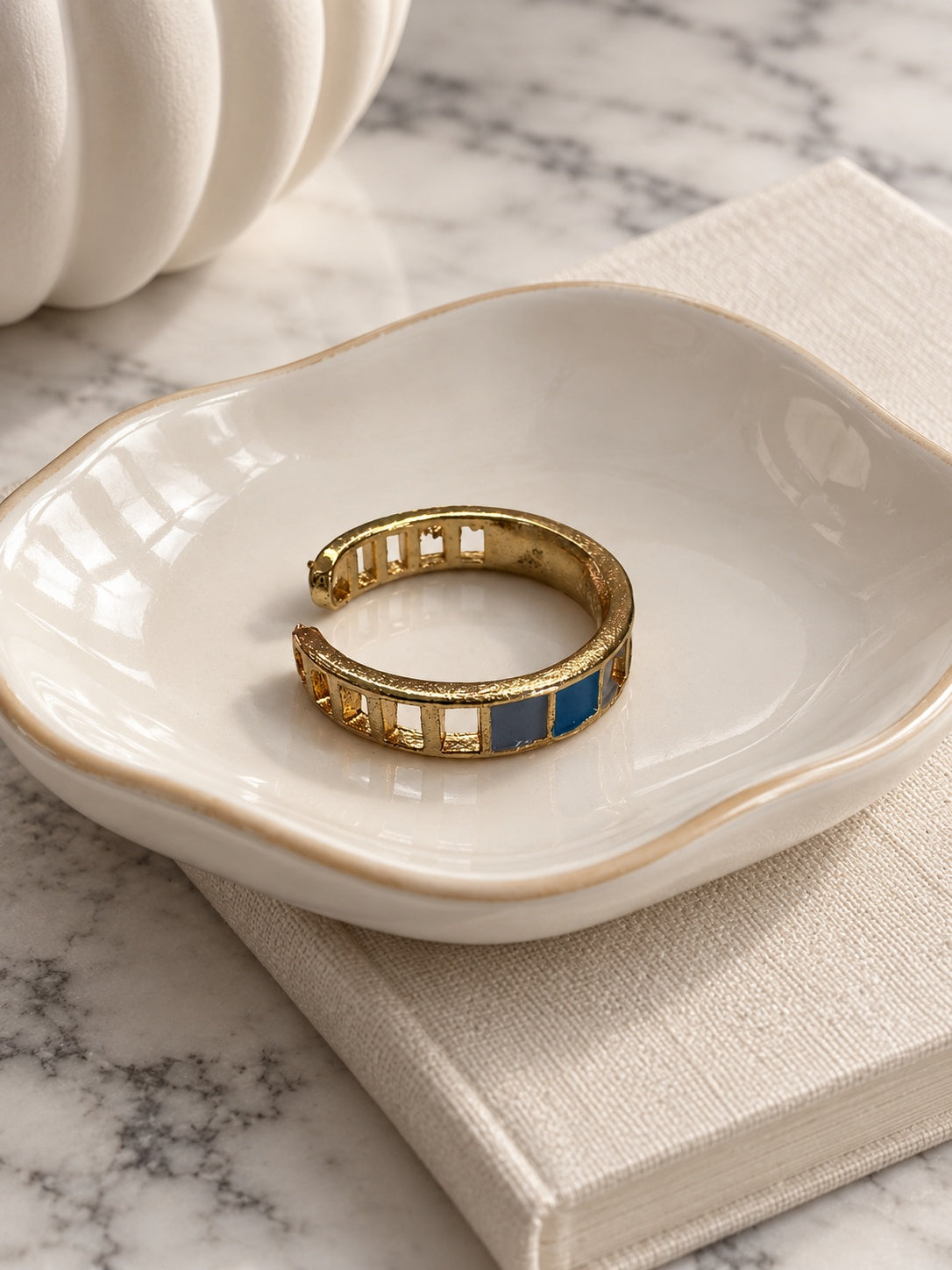 Niska blue and grey mosaic adjustable gold-tone ring in ivory ceramic dish