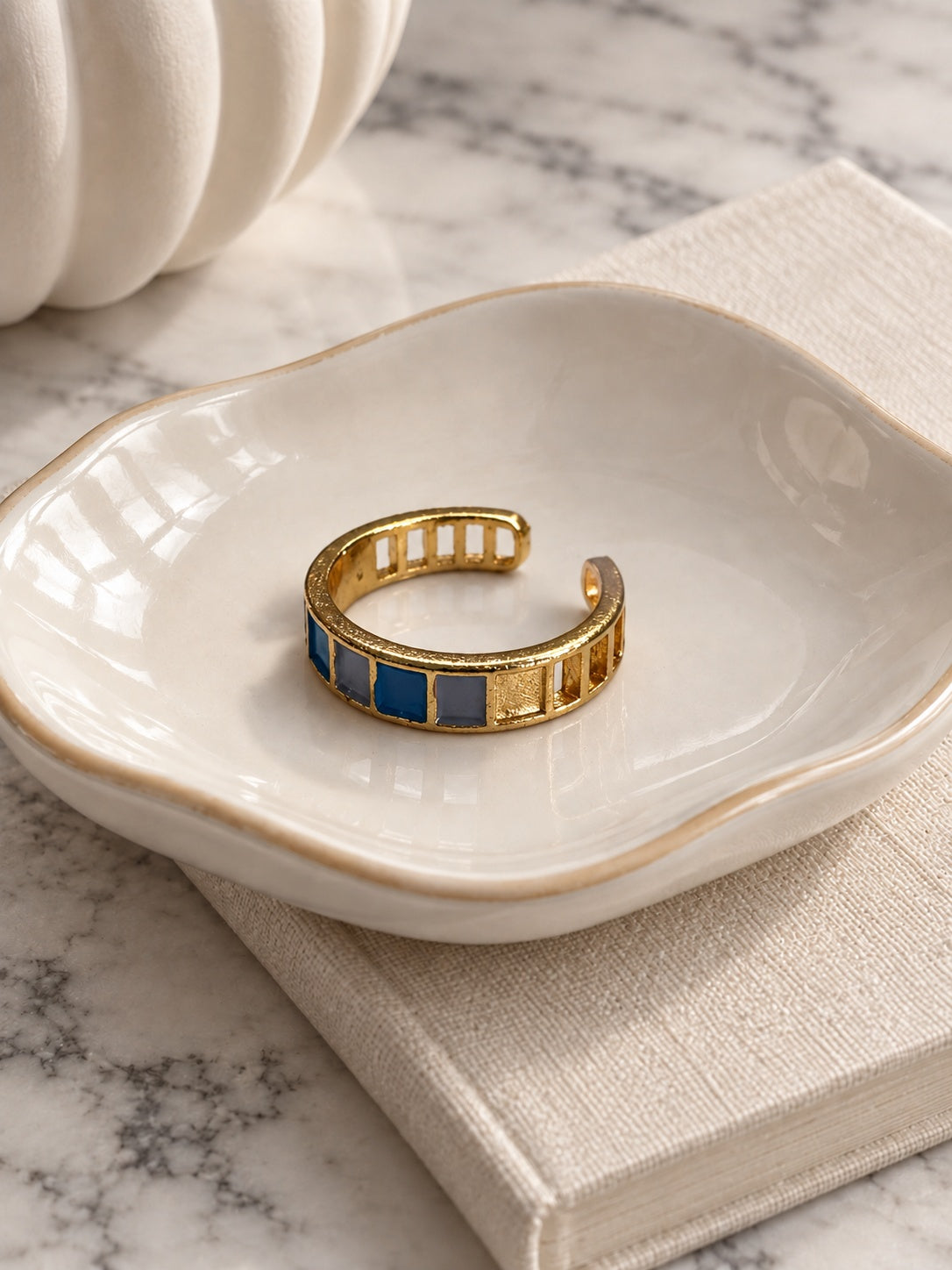 Niska blue and grey mosaic adjustable gold-tone ring in ivory ceramic dish