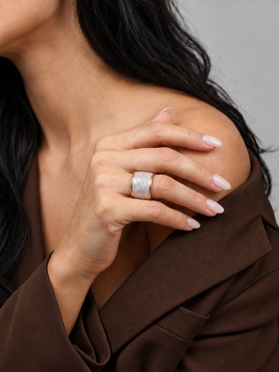 Niska pearl-white gold-tone adjustable wide band ring worn with a brown outfit