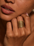 Niska Golden Wave Ribbed Statement Ring worn on model's middle finger