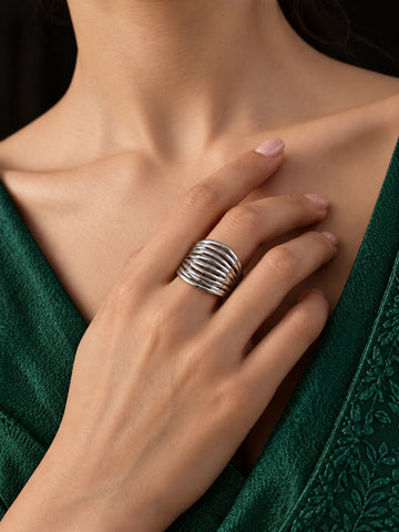 Niska silver replica multi-layer statement ring worn with emerald green dress