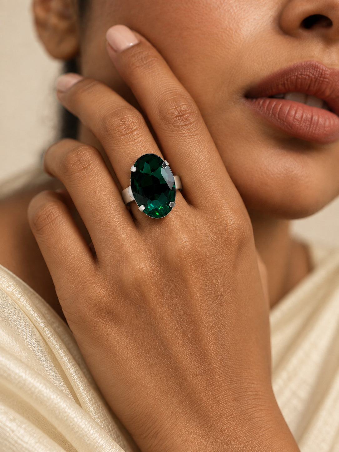 Niska oval green stone silver replica statement ring worn with cream saree