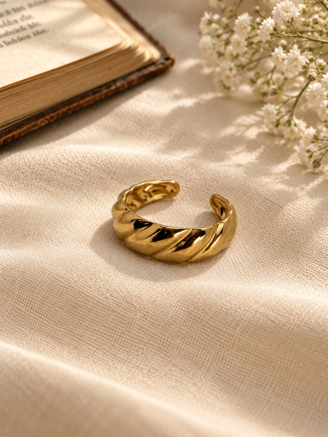 Niska sculpted gold-tone replica ring worn on hand – featured image