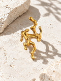 Niska sculptural gold ring on stone surface