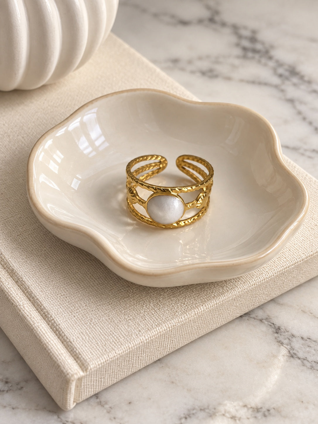 Niska Luna gold-tone white stone openwork ring — model wearing ring