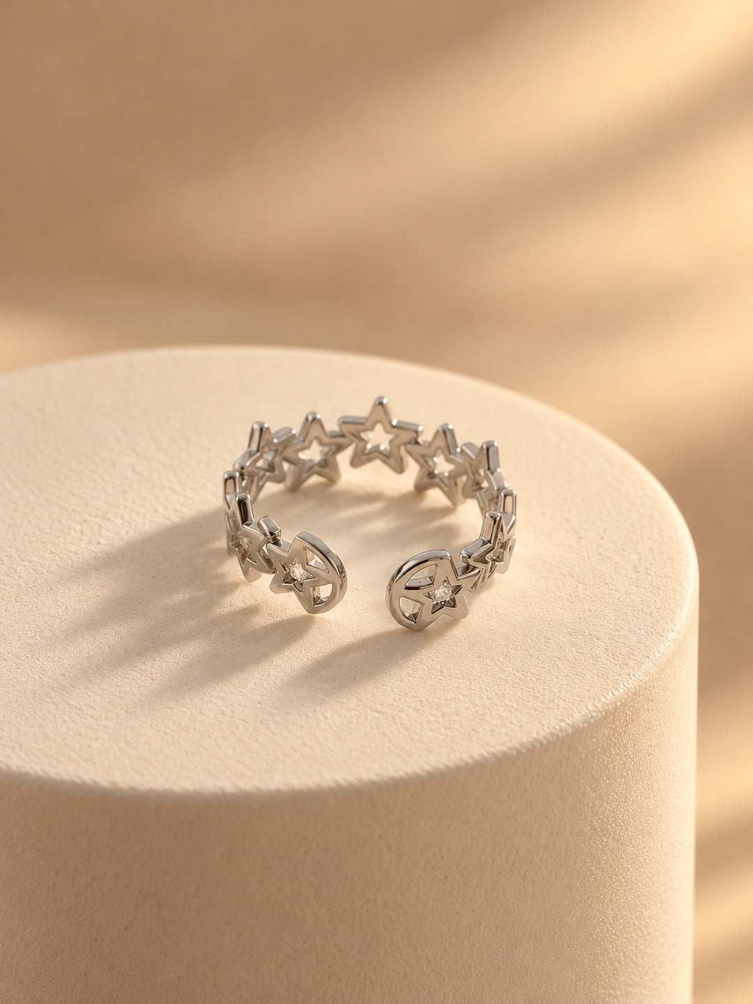 Niska silver-tone open star replica ring without stones worn on model