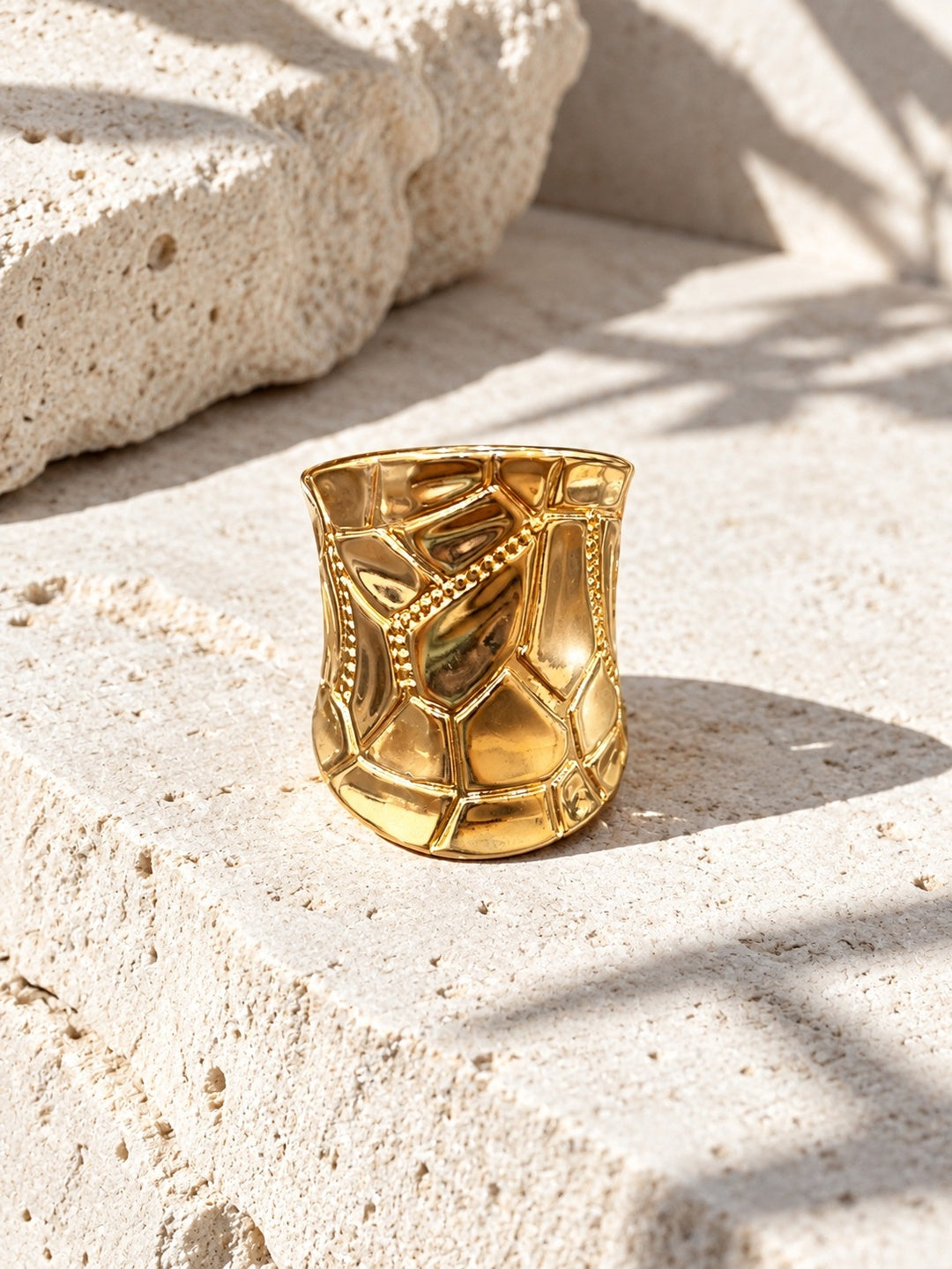 Niska gold statement ring worn in close-up fashion portrait