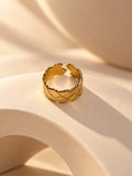 Niska gold-tone geometric statement ring on a cream sculptural platform, view 2