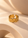 Niska gold-tone geometric statement ring on a cream sculptural platform, view 3