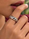 Niska silver-tone twisted band replica ring worn on a model, close-up