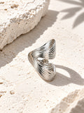 Niska sculptural ring on textured stone surface