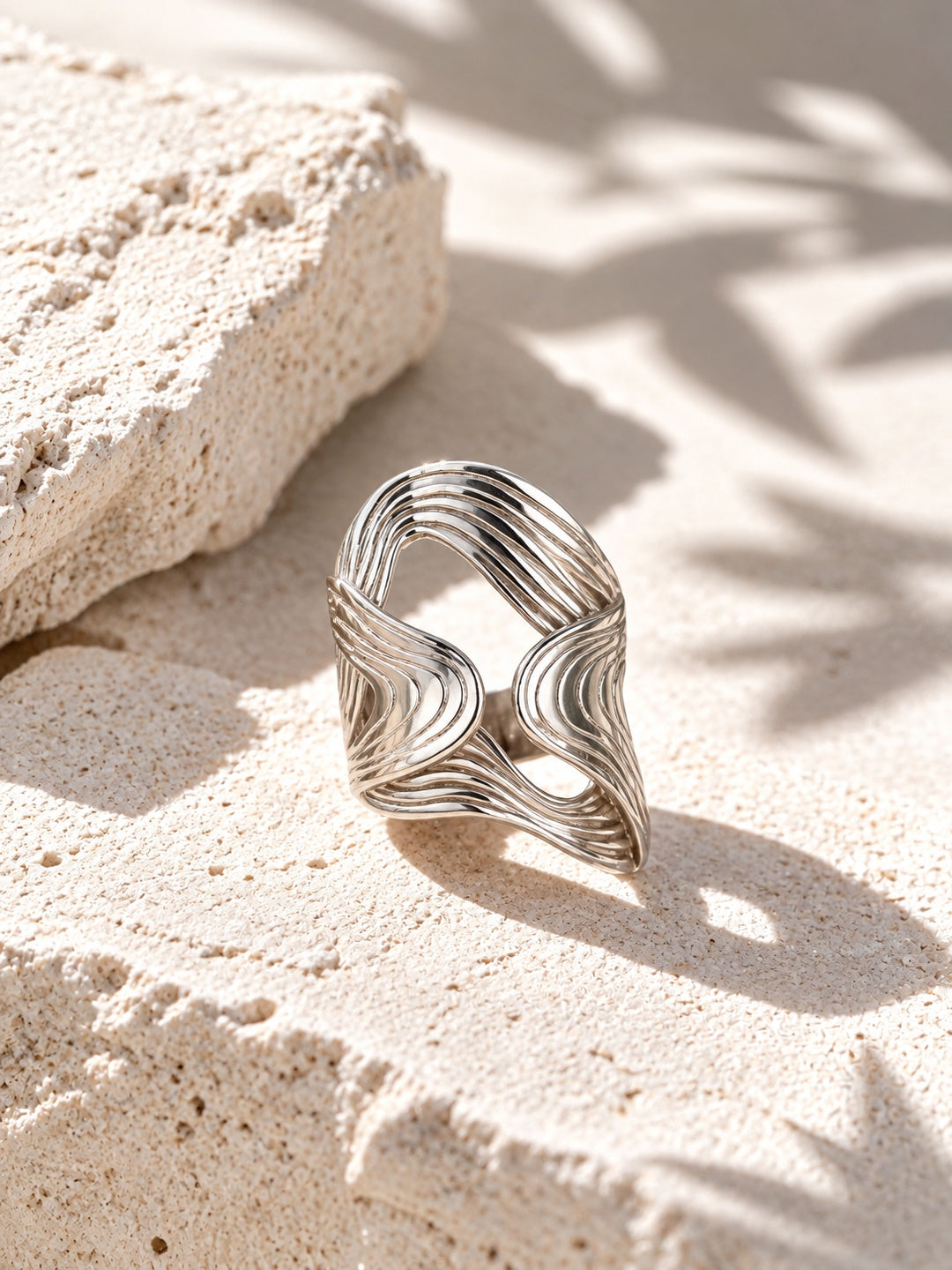 Niska statement ring on white stone in hard light
