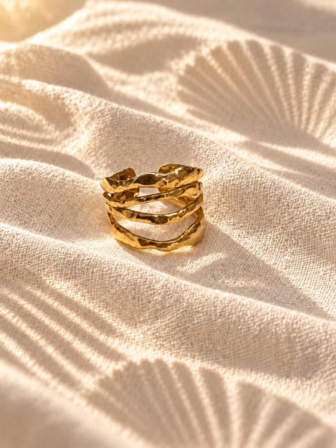 Niska Sculpted Waves gold-tone band ring worn on model