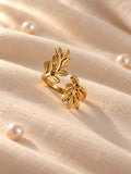 Niska gold-tone botanical leaf replica ring alternate angle on ivory linen