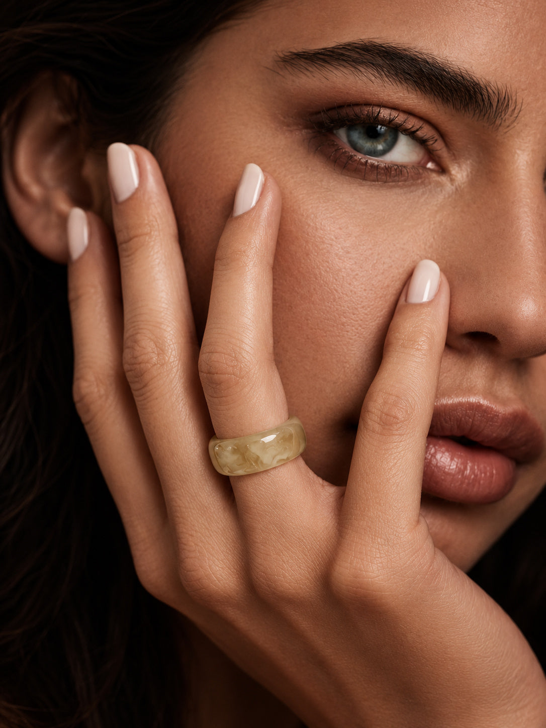Champagne marble ring worn on model hand
