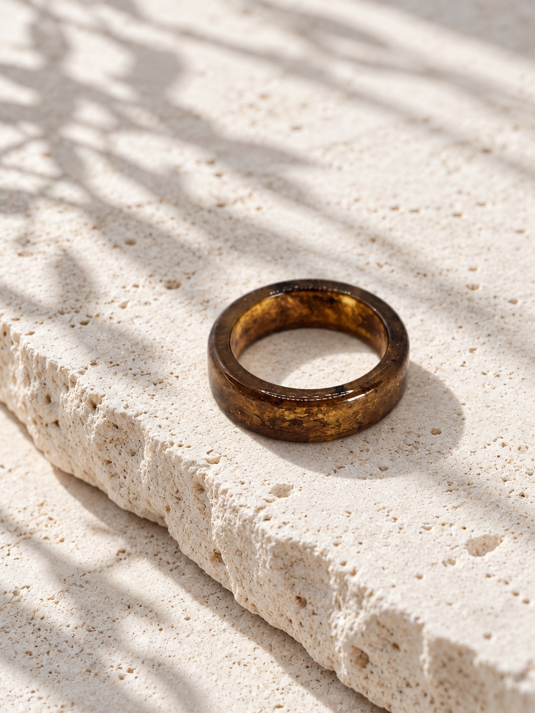 Niska brown and gold-tone replica band ring worn on a model's hand