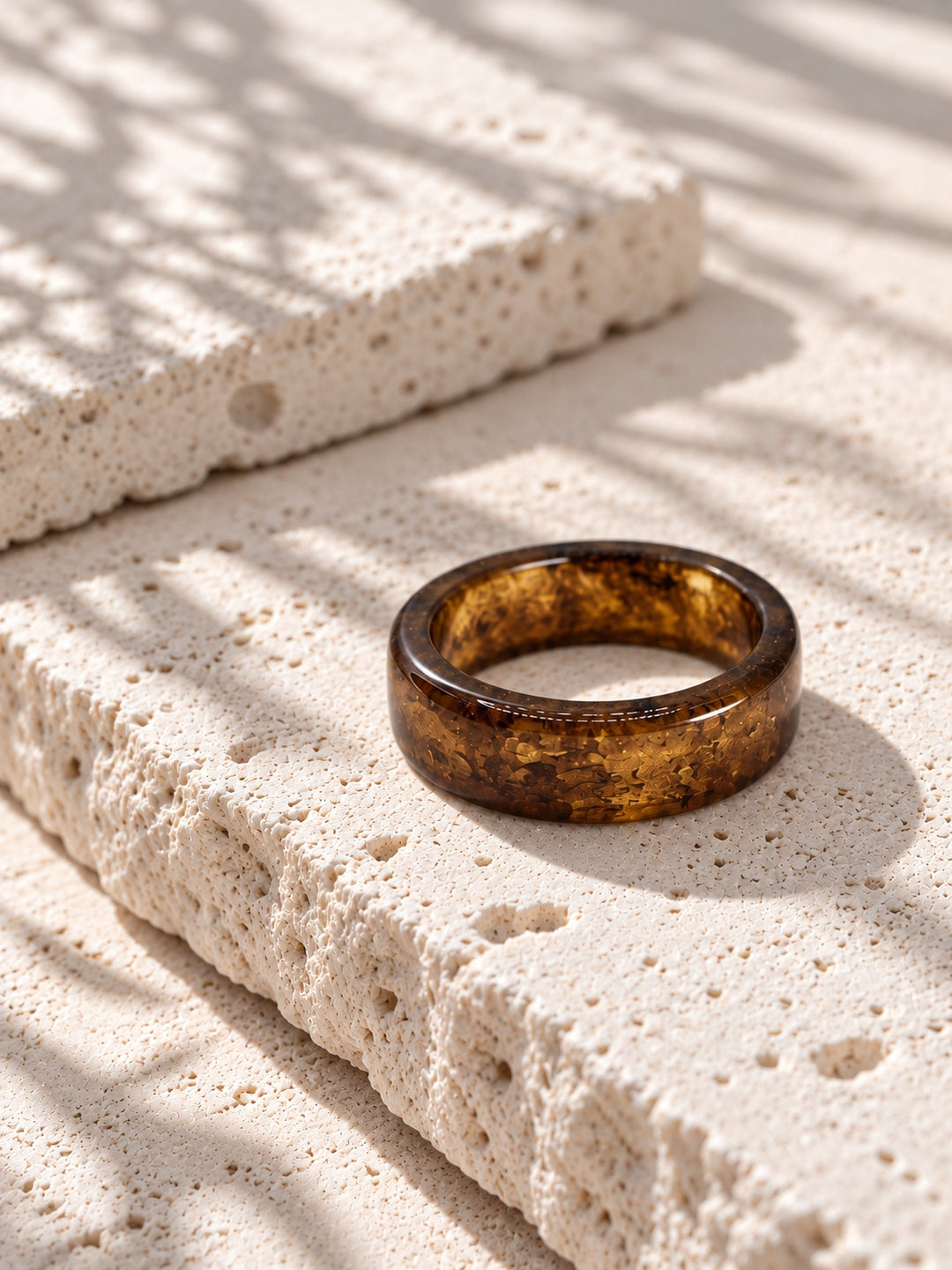 Brown and gold-tone replica band ring on ivory travertine, view 3