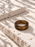 Brown and gold-tone replica band ring on ivory travertine, view 4