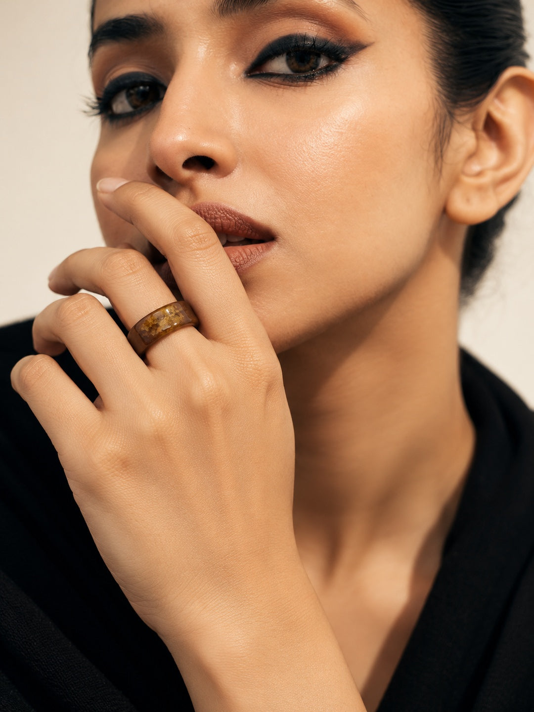Brown and gold-tone replica ring model close-up