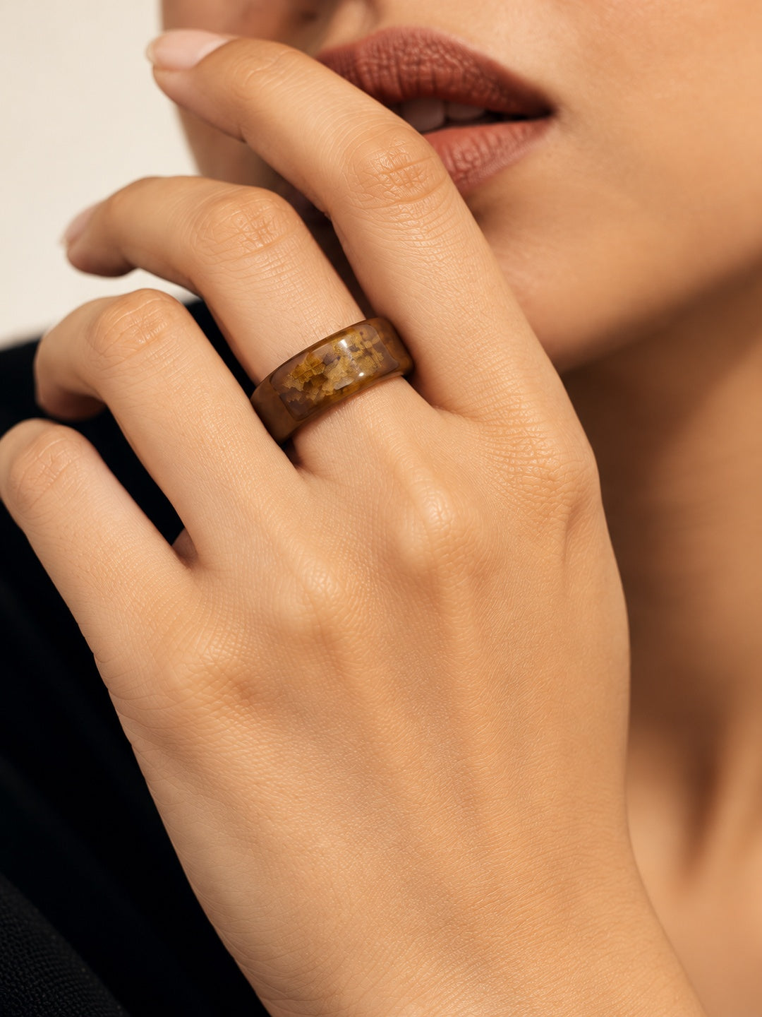 Brown and gold-tone replica ring model close-up