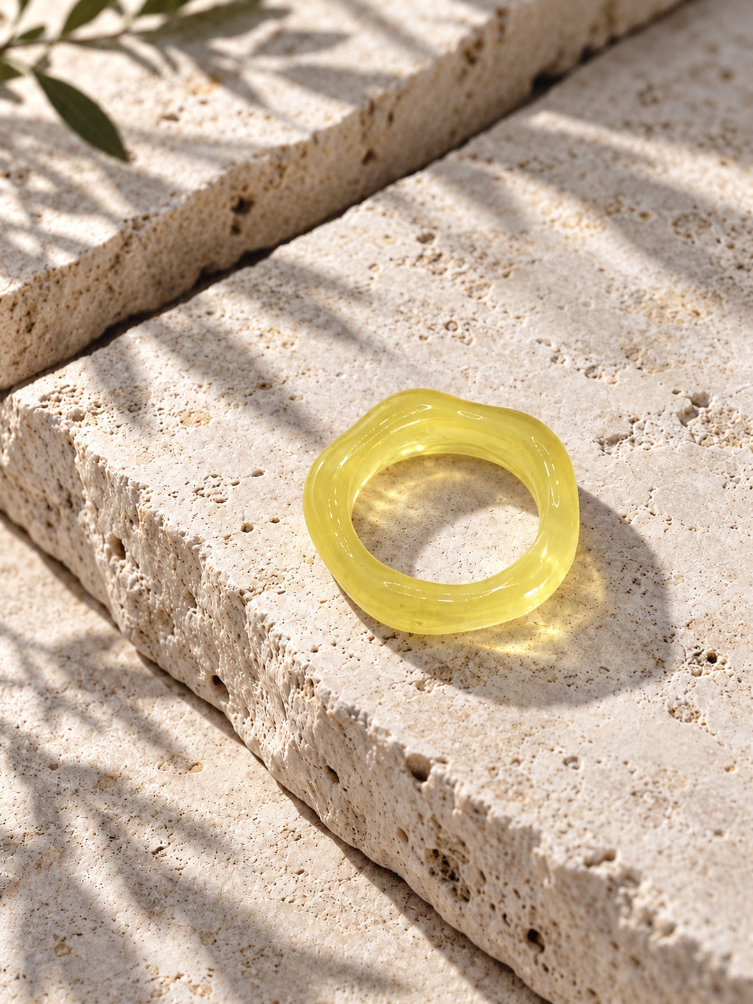 Lemon Glow Sculptural Replica Ring on travertine stone, view 2