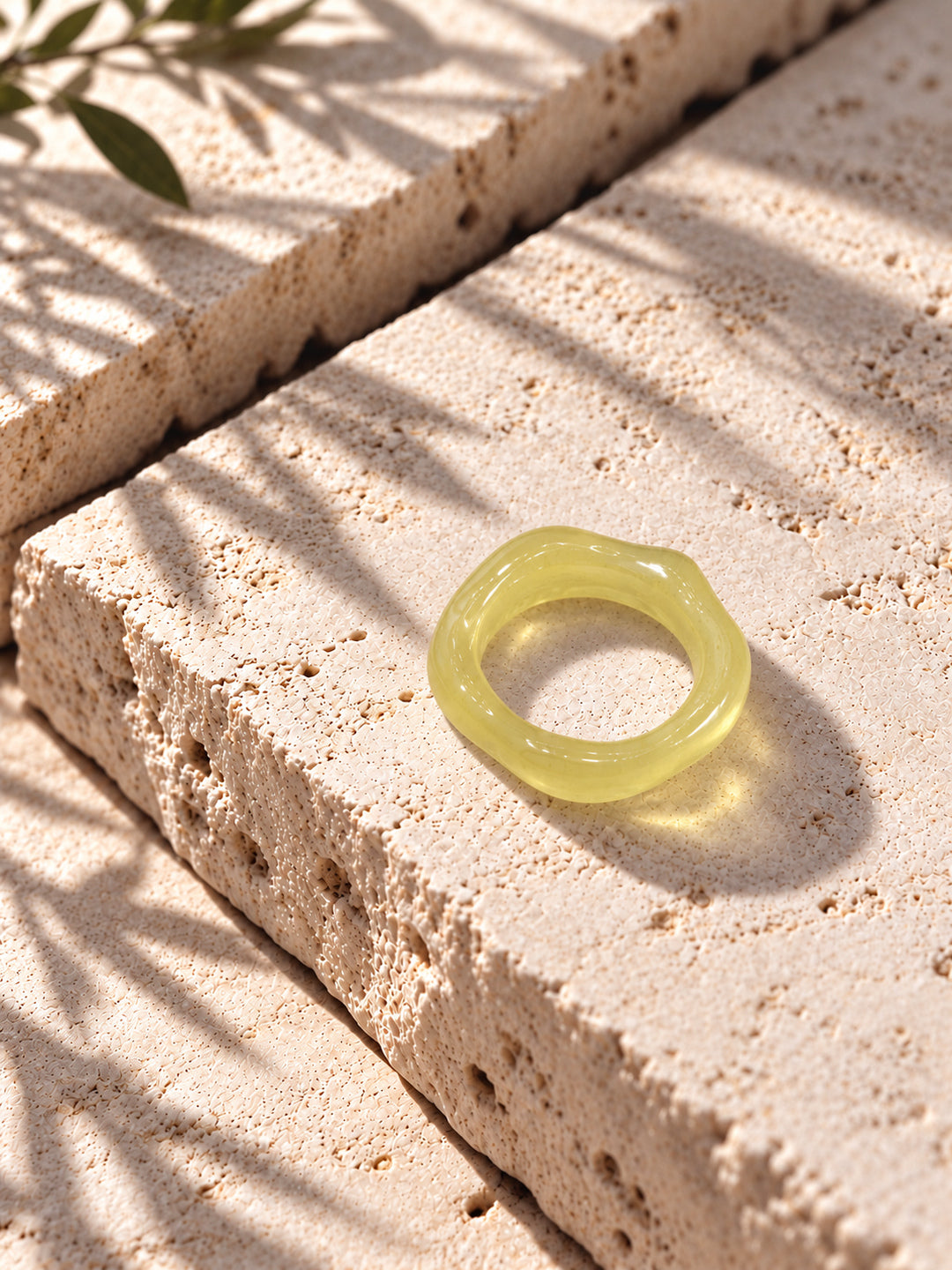 Lemon Glow Sculptural Replica Ring on travertine stone, view 5