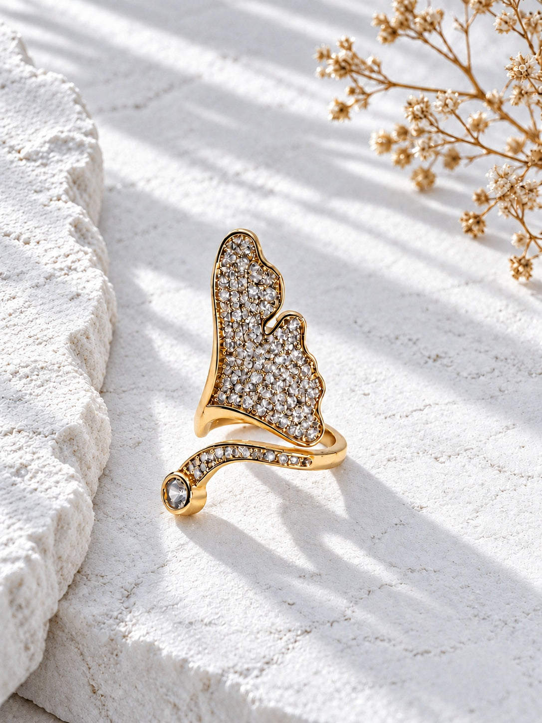 Niska gold-tone statement ring with white stones worn on hand