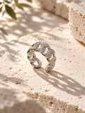 Niska silver-tone stone-studded chain link replica ring on travertine