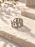 Niska silver-tone stone-studded chain link replica ring on travertine