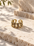 Gold tone AD stone chain link ring front view on white travertine