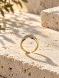 Niska gold-tone AD Stone split-band ring on travertine