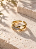 Niska gold-tone AD Stone split-band ring on travertine