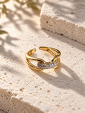 Niska gold-tone AD Stone split-band ring on travertine