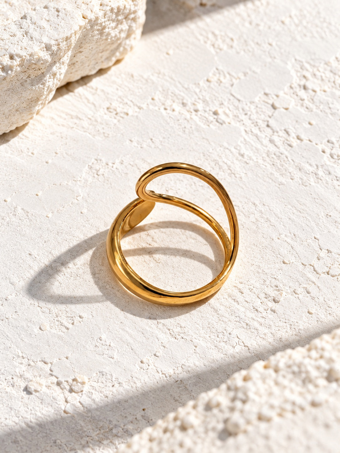 RI26N10455 gold open ring on white stone
