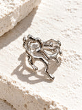 RI26N10180 silver plated sculptural ring on white stone