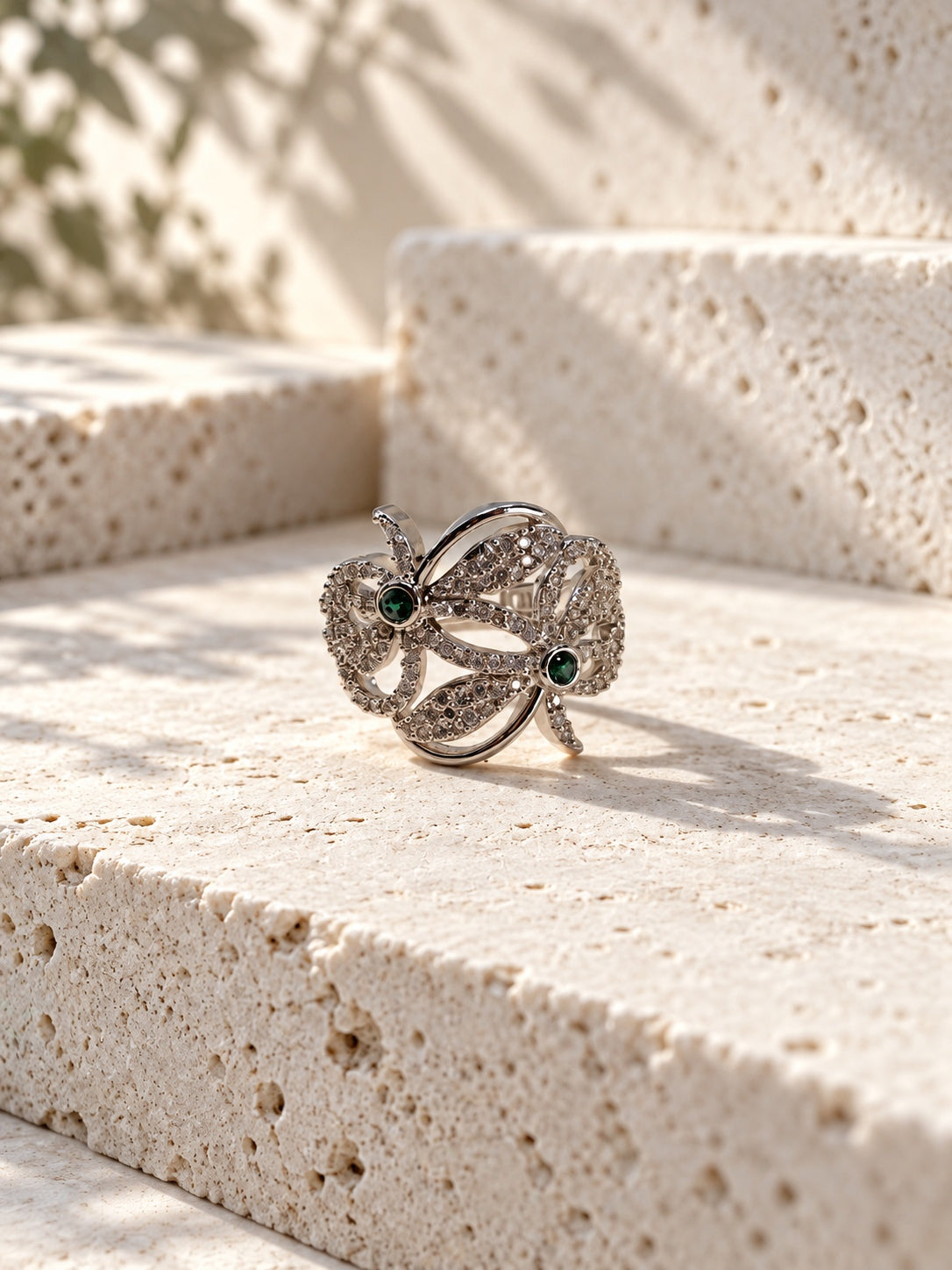 Niska green floral AD stone ring worn on a model's hand