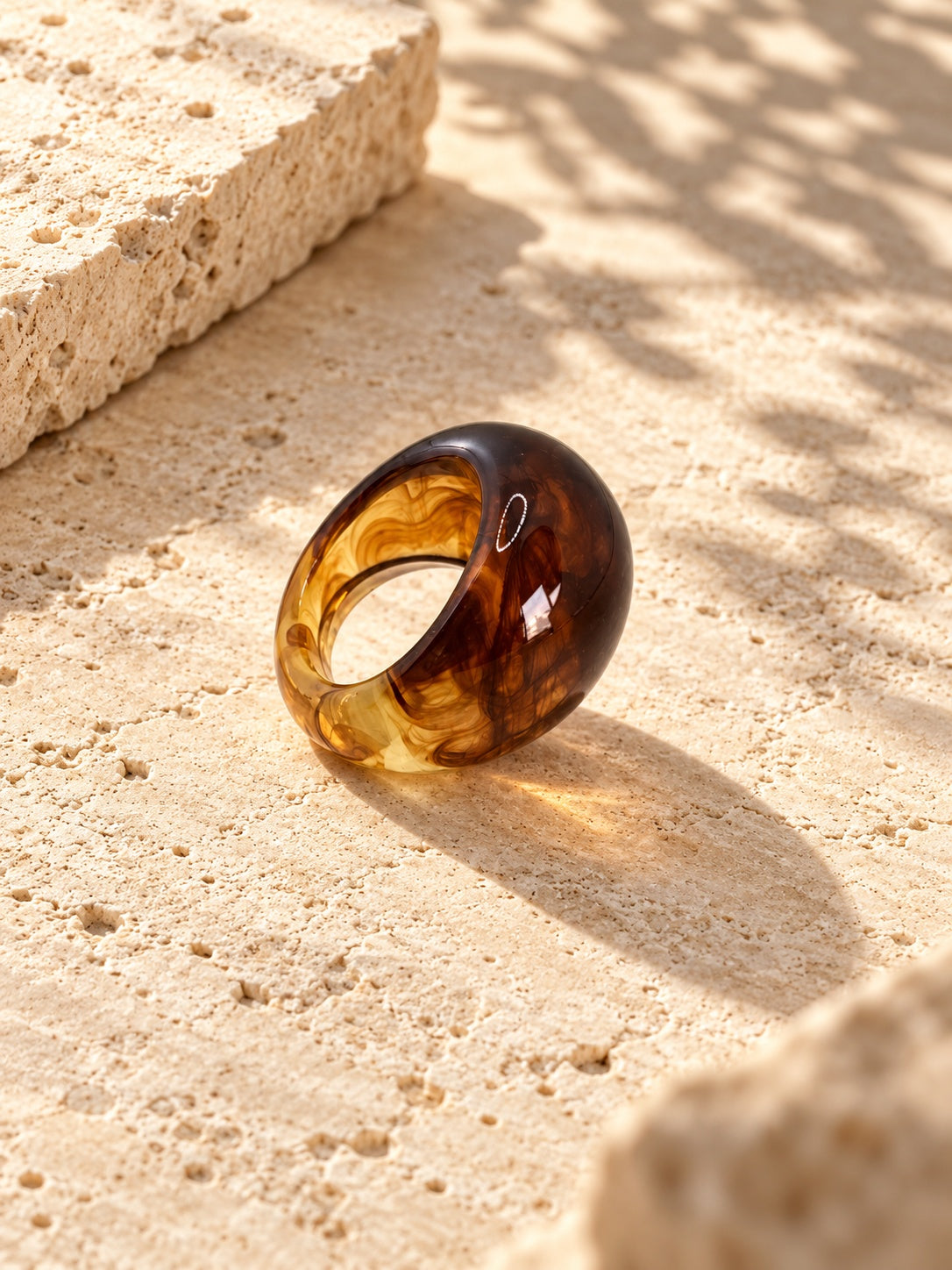 Niska amber swirl chunky replica ring on ivory travertine, view 1