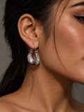 Niska engraved oxidised silver-tone alloy hoop earring worn on model
