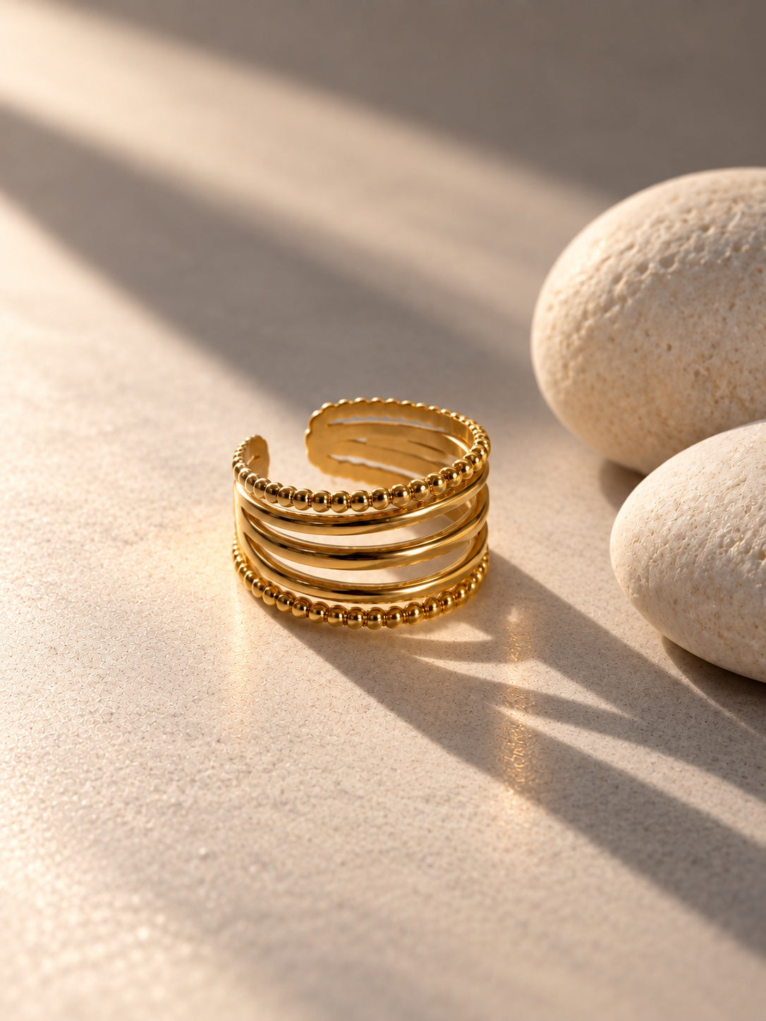 Niska gold-tone beaded multi-band ring worn on model