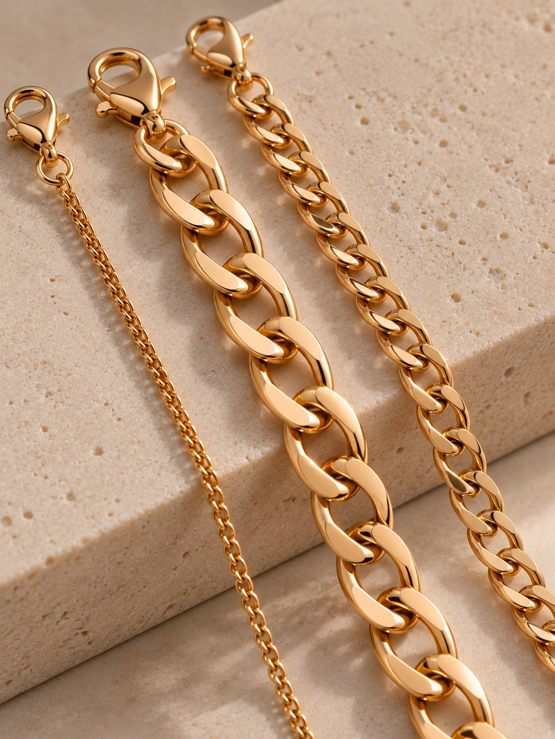 Niska gold-tone chain bracelet replica trio on cream stone