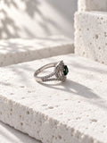 Niska green oval AD stone swirl ring in silver tone