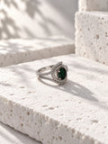 Niska green oval AD stone swirl ring in silver tone